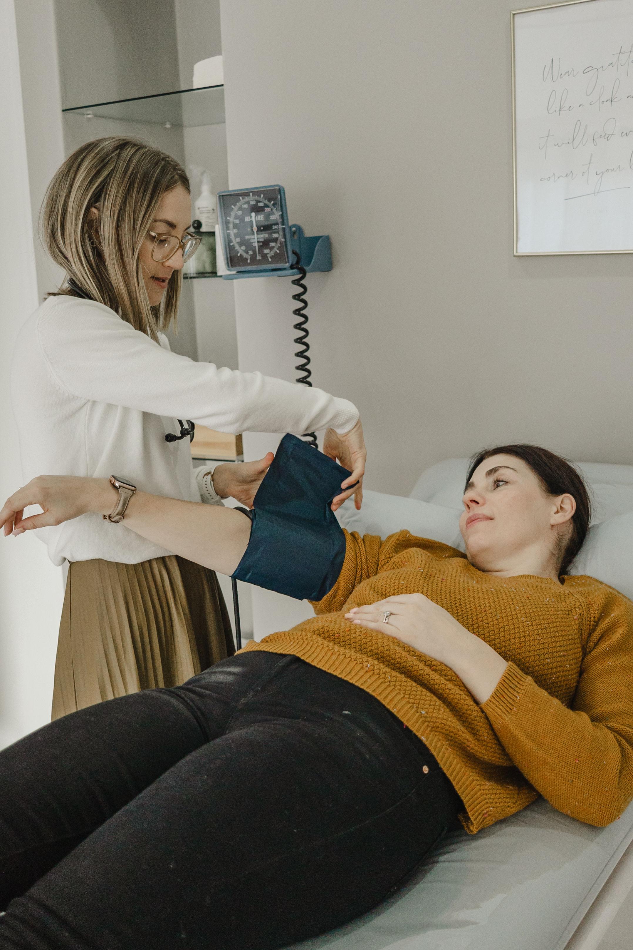 Dr Lana Bouwer taking a patient's blood pressure during a consultation
