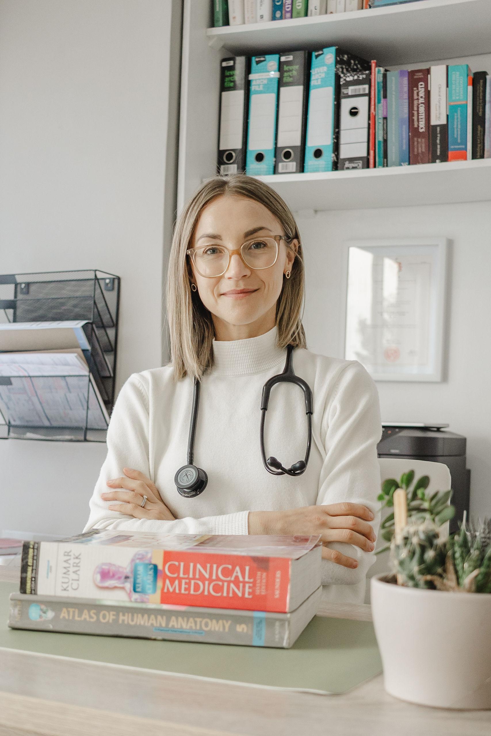 Dr Lana Bouwer at her desk surrounded by clinical reference books